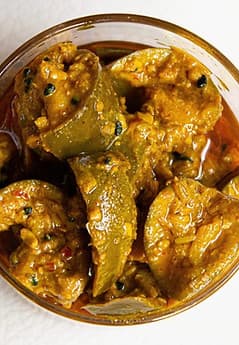 Introducing Home made Lasoda Gunda Pickle. Made with high quality raw Lasoda Gunda, this traditional home-style pickle packs in a mouth-watering combination of spicy and tangy flavors. The ideal balance of skillfully selected spices, aromatic oil and fresh Lasoda Gunda Pickle, adds a lip-smacking punch to your daily meals. The mustard oil used to pickle the Lasoda Gunda Pickle adds to the robust taste, texture, and aroma of the product. The Lasoda Gunda pickle is a flavorsome condiment that enhances the taste. DM for order 250gms 175rs